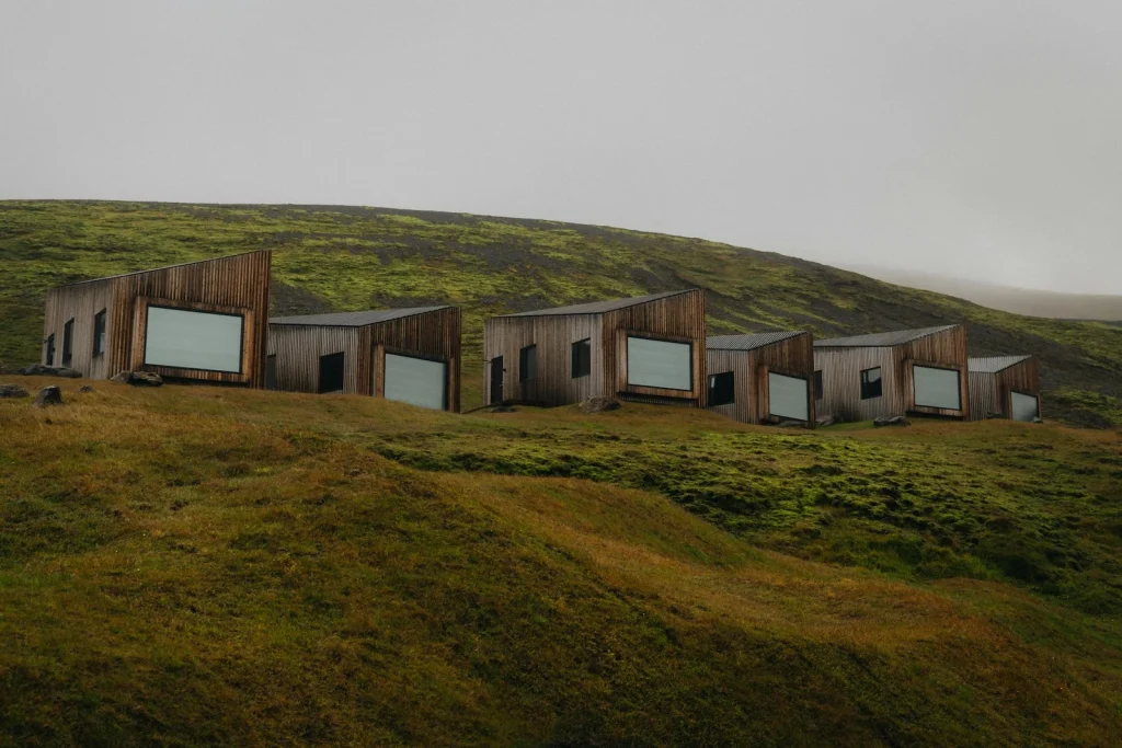 A group of buildings sitting on top of a lush green hillside